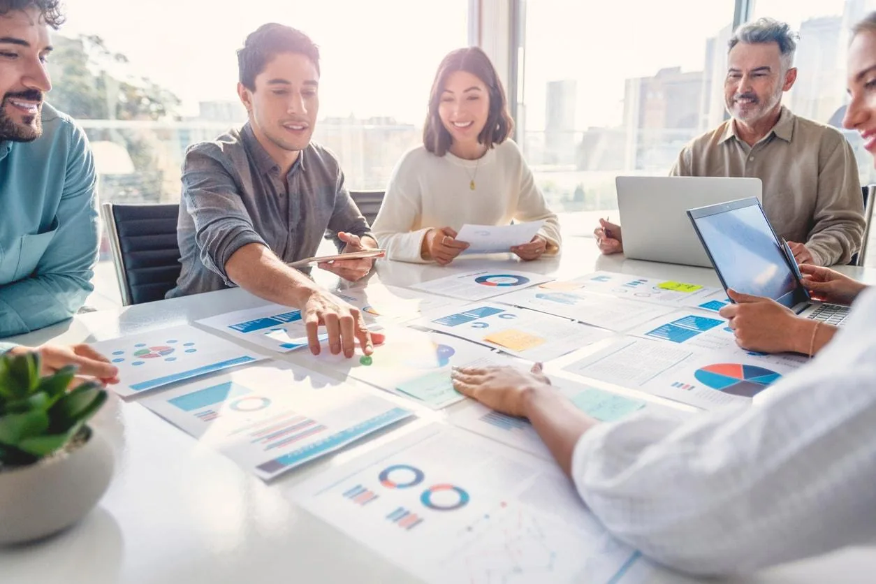 Team reviewing financial planning materials in a modern office